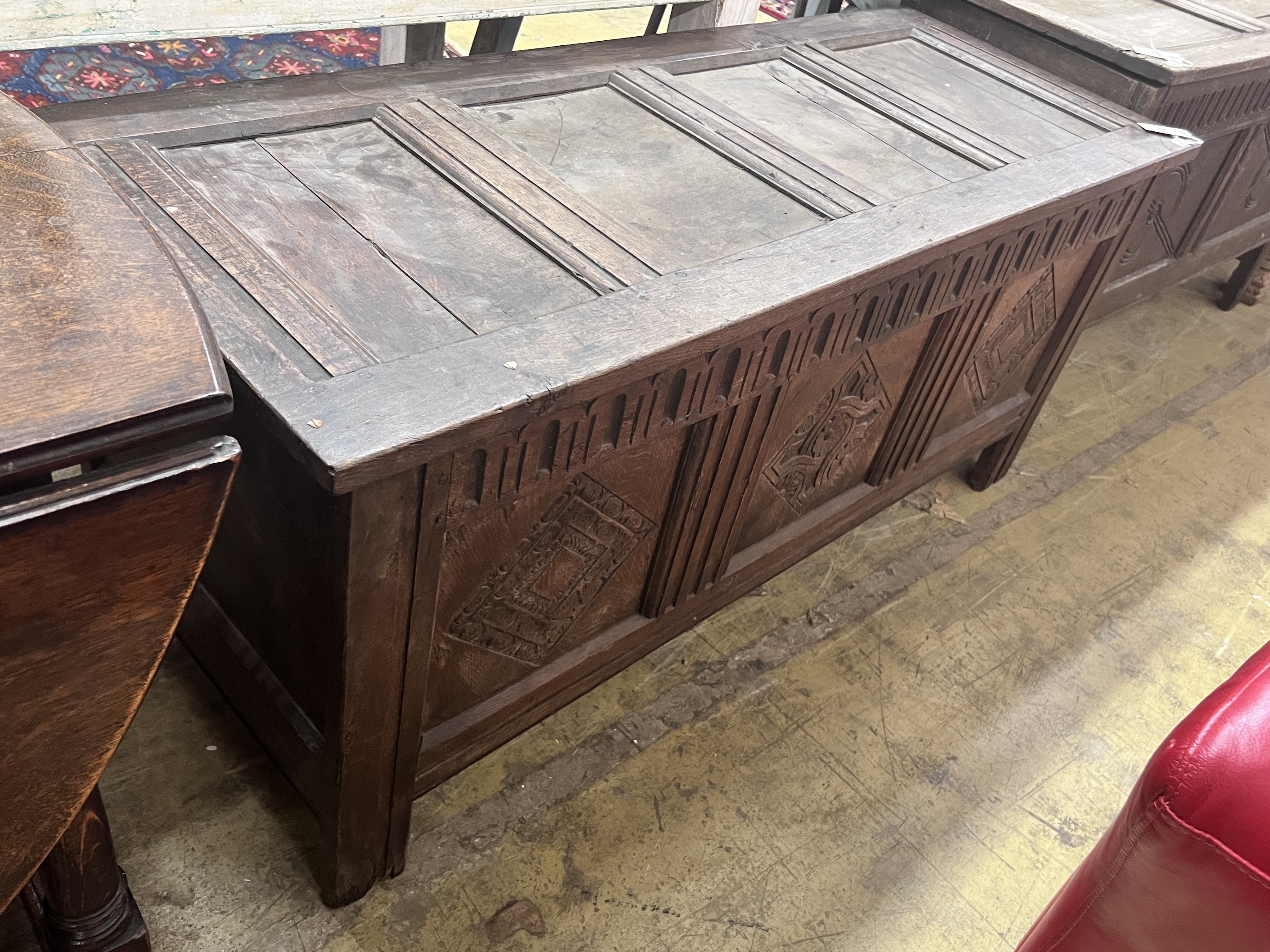 An 18th century carved oak coffer, length 142cm, depth 55cm, height 62cm